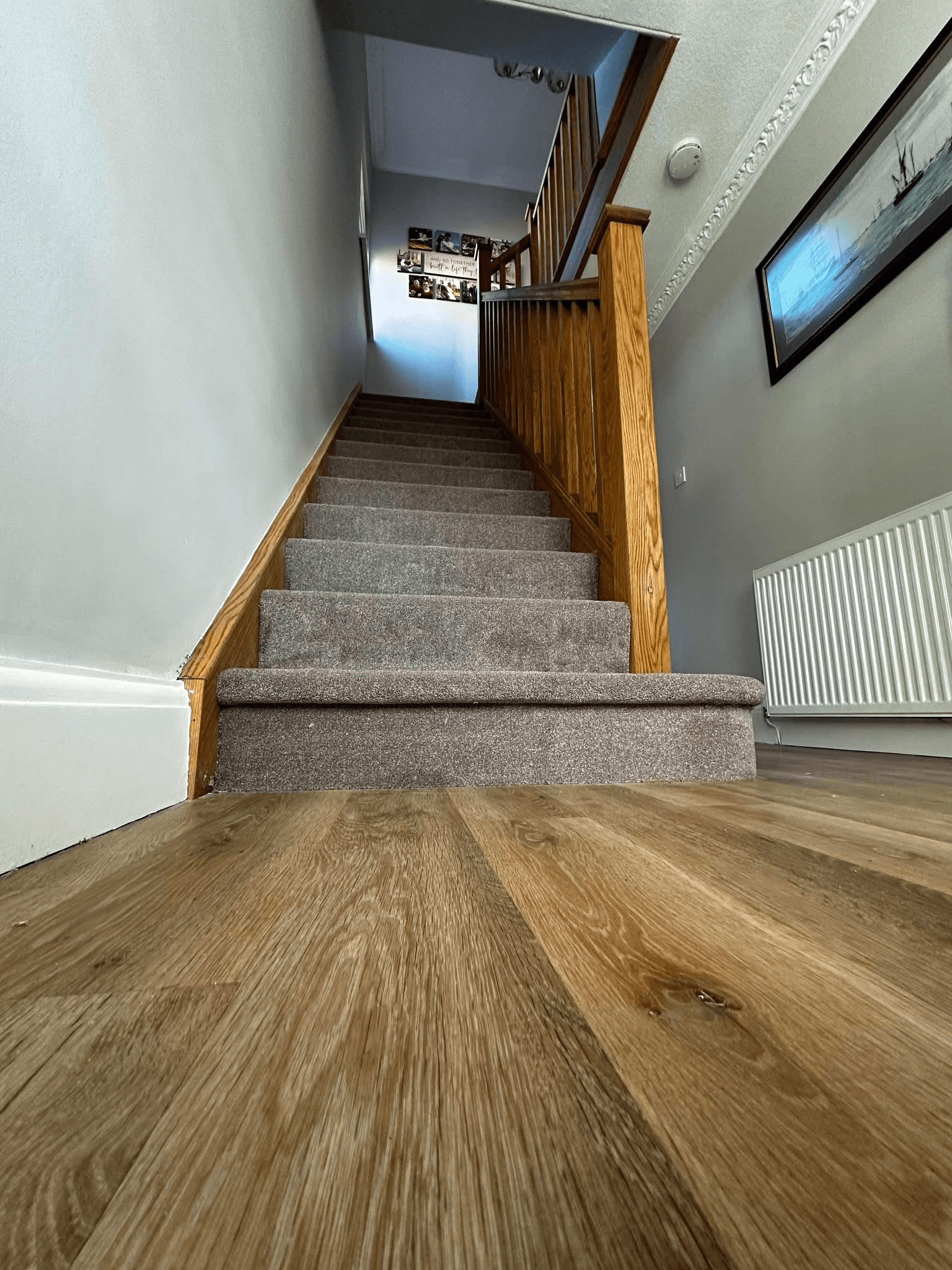 Oak laminate hallway with carpeted stairs