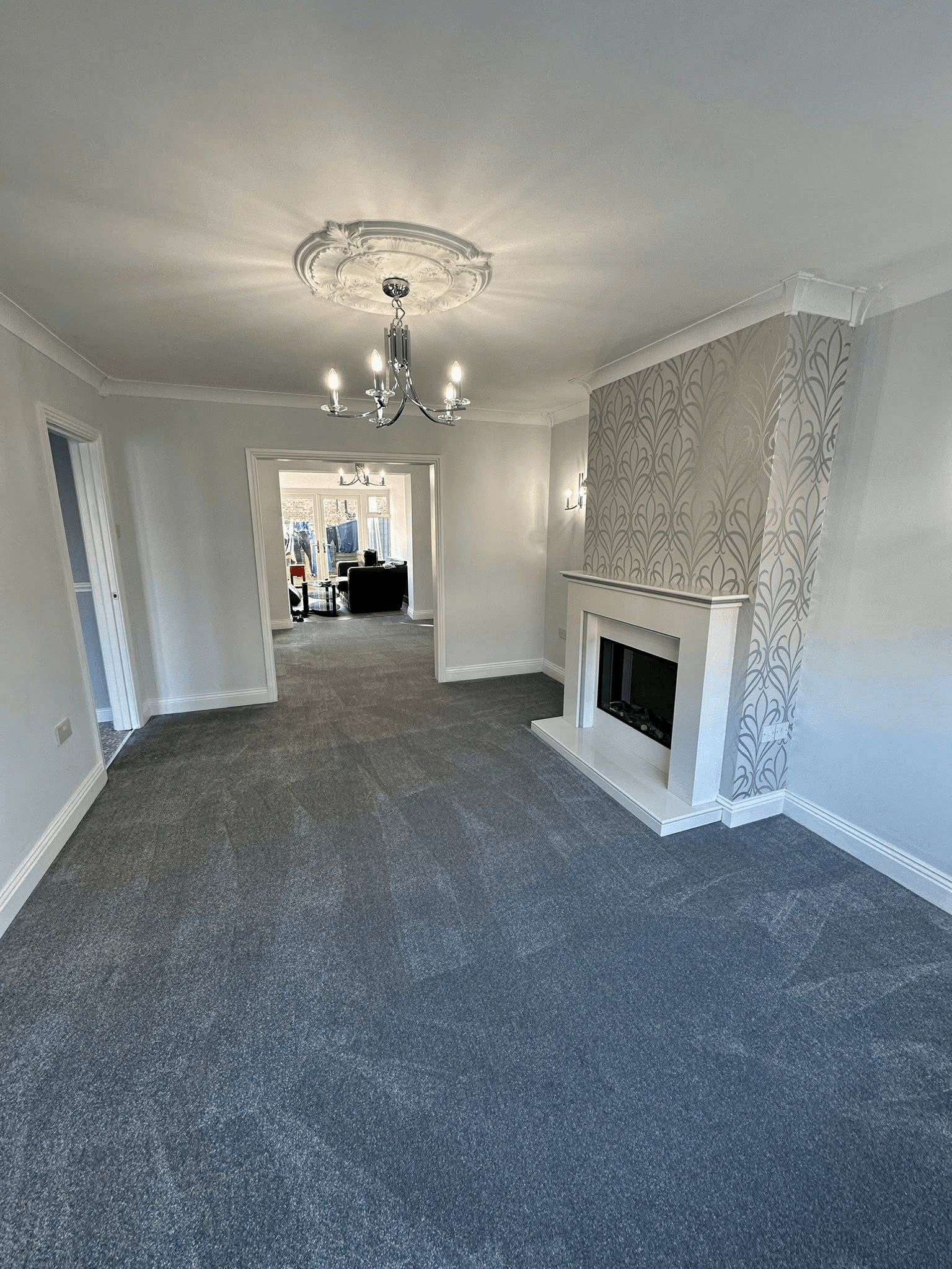 Charcoal carpet fitted in spacious living room with chandelier, South Shields