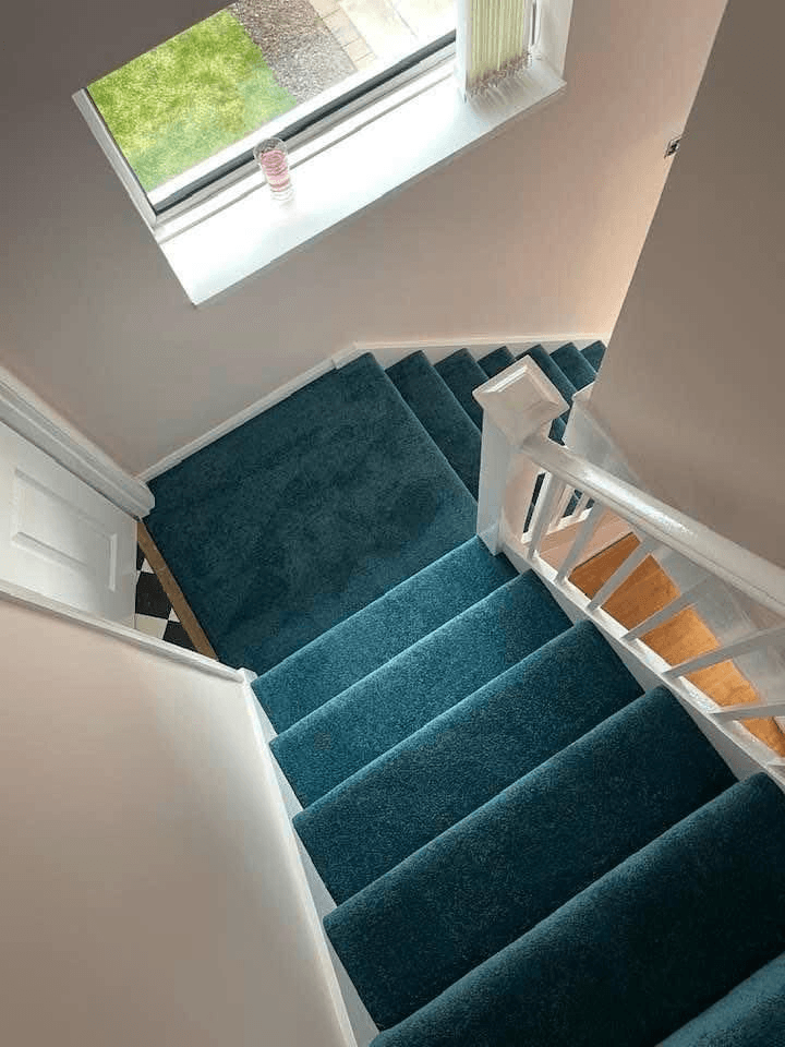Teal blue carpet fitted on staircase viewed from above